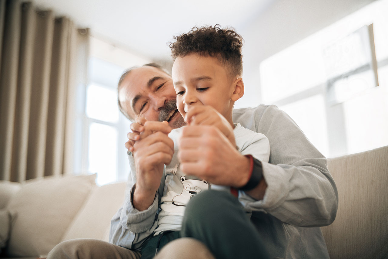 pexels-mikhail-nilov-6973194 (1) Grandfather with grandson on lap