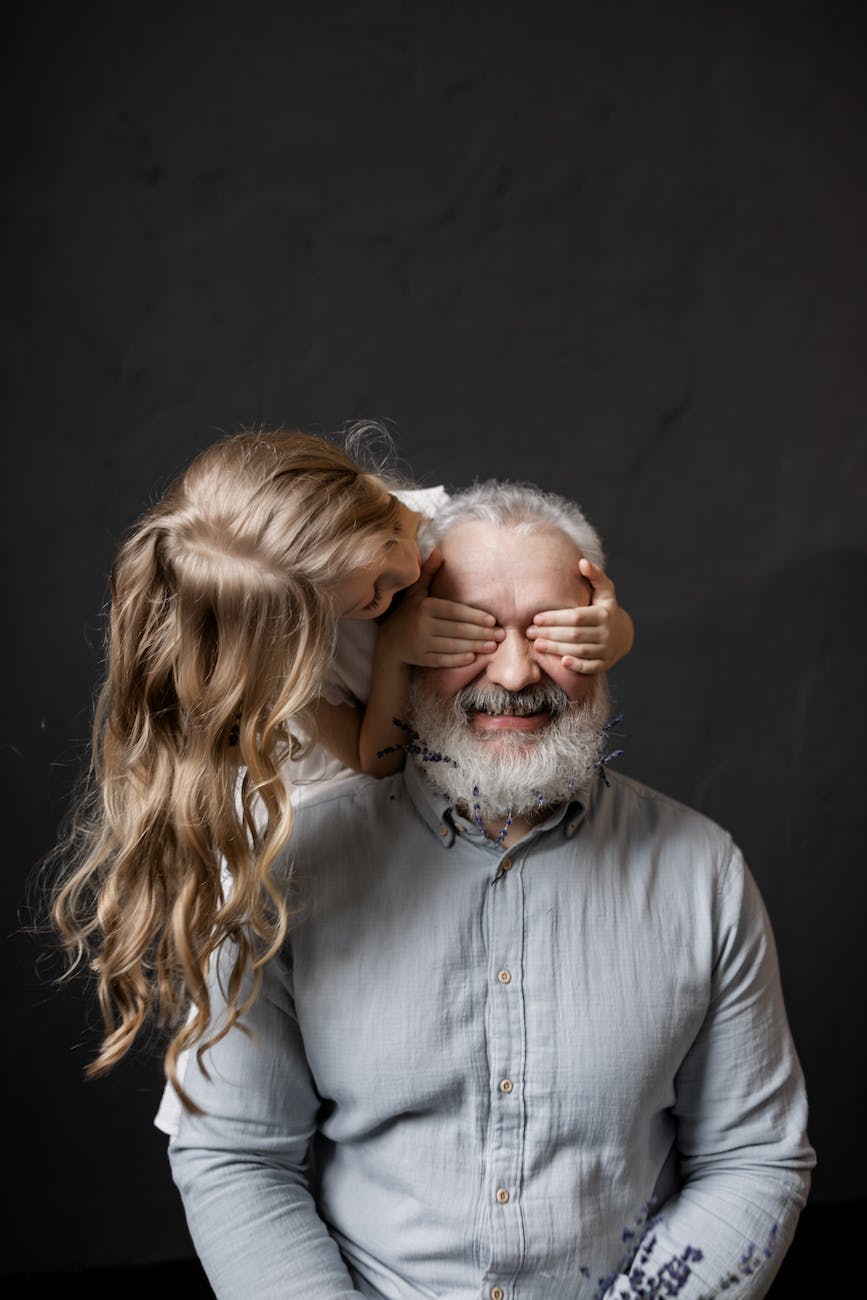 granddaughter playing with her grandfather