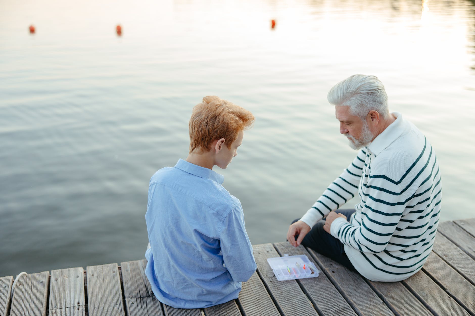 pexels-photo-8916855-1 a grandfather teaching a boy about fishing baits