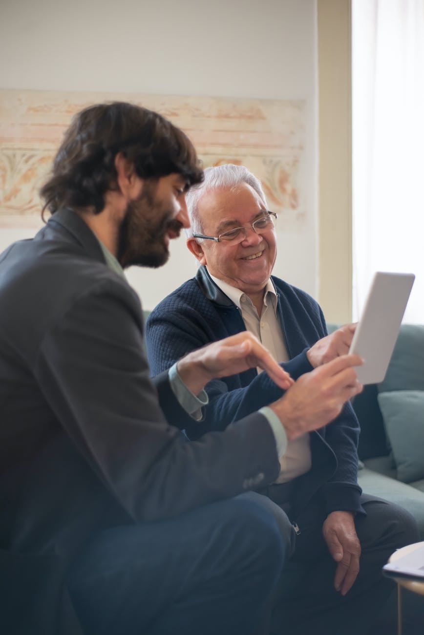 pexels-photo-8439675 businessmen sitting in an office and looking at a document
